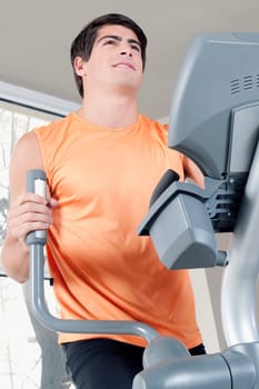 Man exercising on a stepping machine in a gym