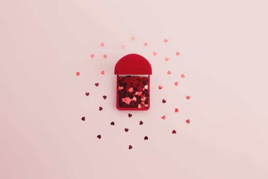 Red heart glitters on the pink background. High quality photo