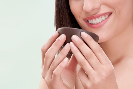 Woman smelling moisturizer cream