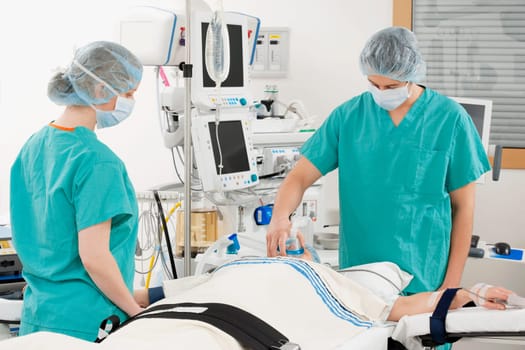 Anesthetist using an oxygen mask on a patient in a hospital