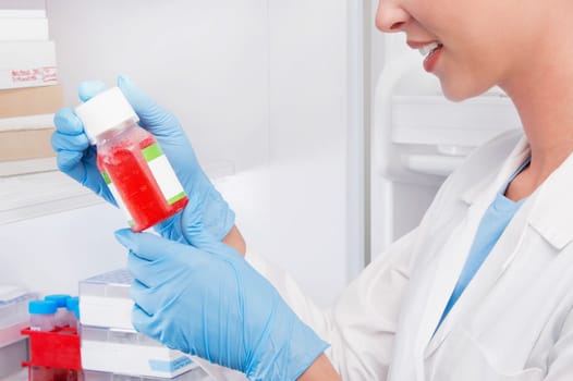 Female doctor holding a bottle of solution in a laboratory