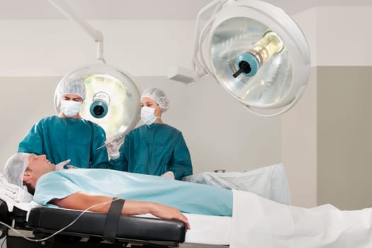 Two surgeons operating a patient in an operating room