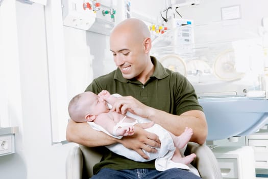 Man carrying his newborn baby