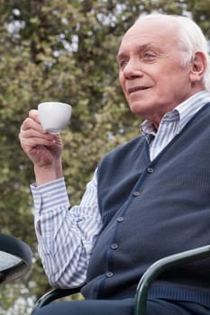 Man sitting on a chair and drinking tea