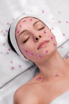 Woman receiving facial treatment