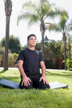 Man practicing yoga in a park