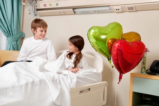 Two children in a hospital ward