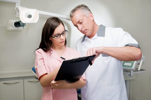 Two doctors discussing a report