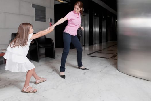 Girl tugging her mother in a hospital