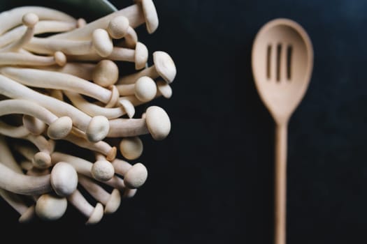 Cooking white mushrooms on the dark gray background. High quality photo
