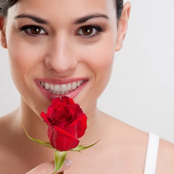Portrait of a woman smelling a rose