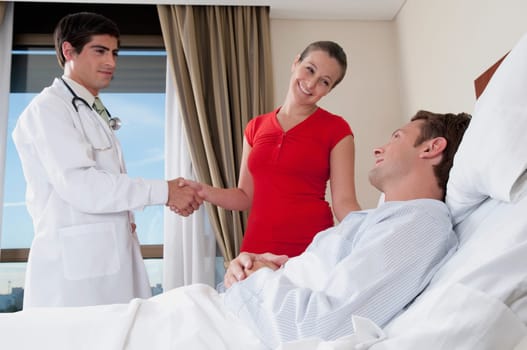 Woman shaking hand with a doctor