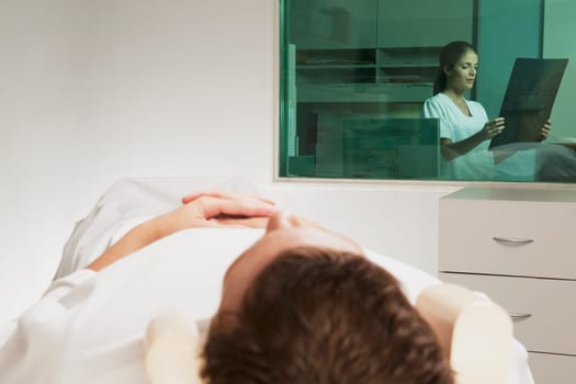 Nurse examining MRI scan of a patient