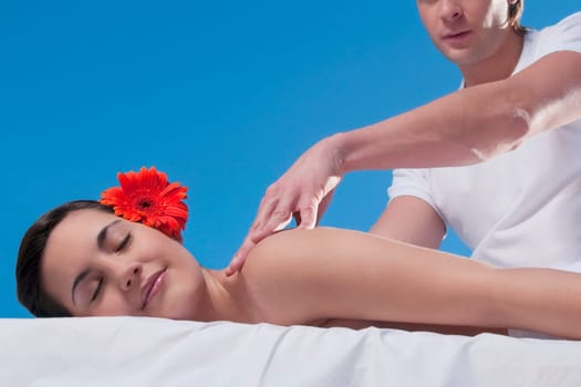 Woman receiving back massage from a massage therapist