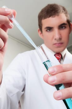 Lab technician analyzing sample in a test tube
