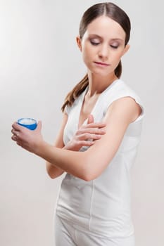 Woman applying moisturizer on her hand