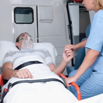 Female nurse assisting a patient in an ambulance