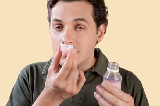 Man smelling medicine syrup