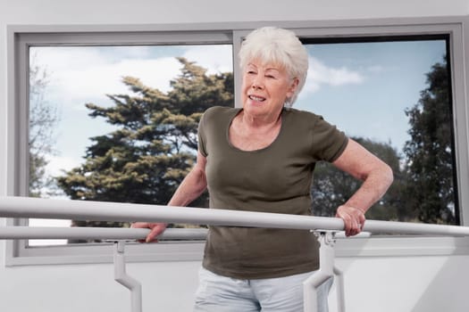 Disabled woman practicing on a walker