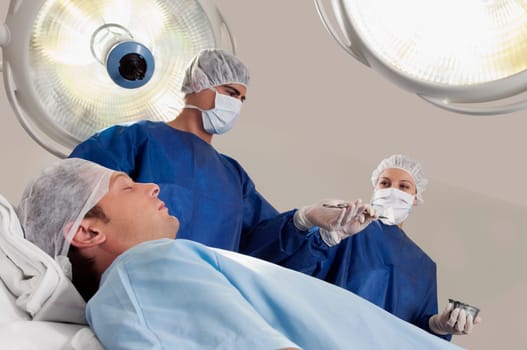 Two surgeons operating a patient in an operating room