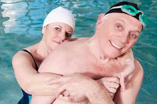 Portrait of a couple smiling in a swimming pool