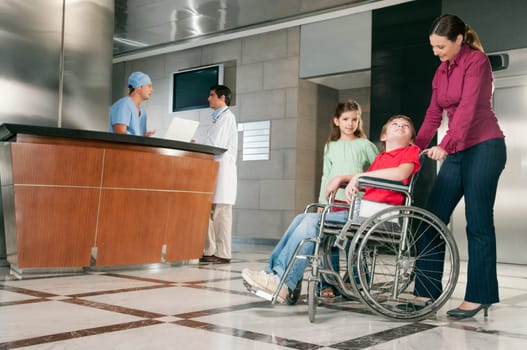 Woman pushing her son in a wheelchair