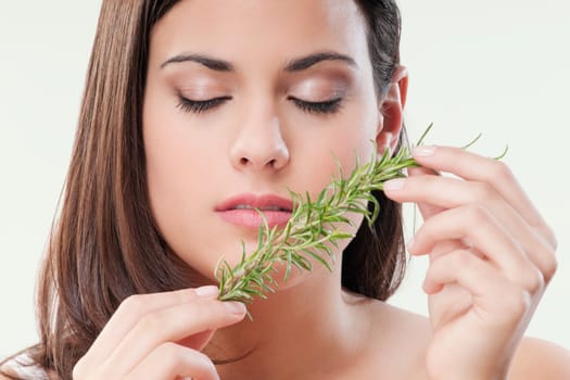 Close_up of a woman smelling aroma herbs