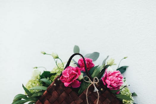 Beautiful pink flowers in the wooden basket. . High quality photo