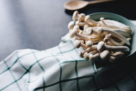 Cooking white mushrooms on the dark gray background. High quality photo