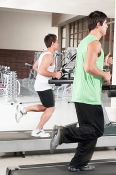 Two men running on treadmills