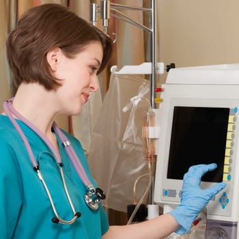 Female doctor working on a cardiac monitor