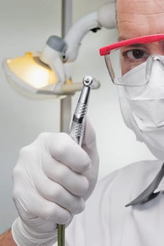 Dentist holding a dental drill