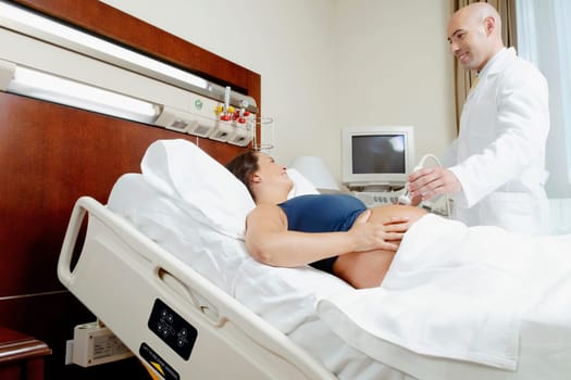 Pregnant woman going through an ultrasound scan