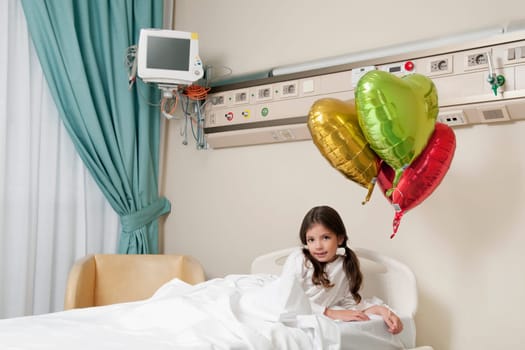 Girl lying in a hospital bed