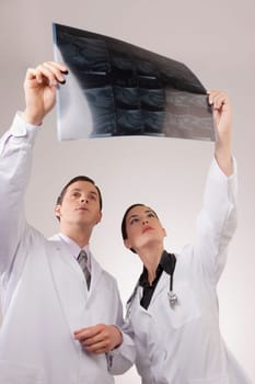 Doctors examining an x_ray report