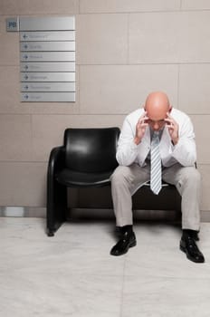 Doctor sitting on a chair and looking stressed