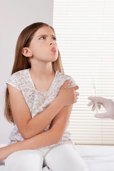 Doctor giving an injecting to a girl