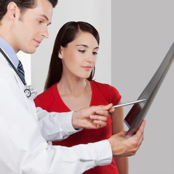 Doctor explaining x_ray report to a patient