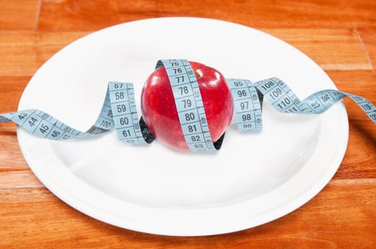 Apple wrapped in a tape measure