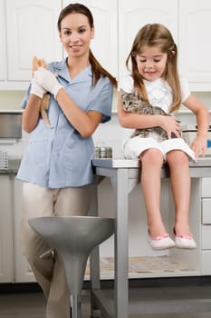 Female vet with a girl carrying cats