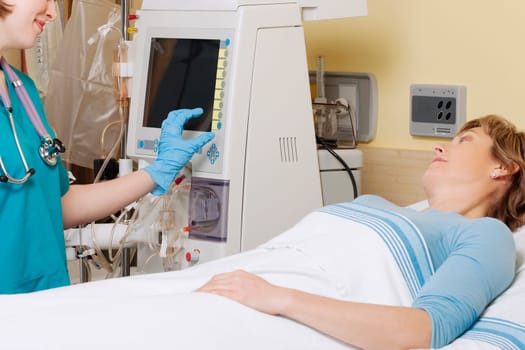 Female doctor working on a cardiac monitor