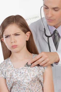 Doctor examining a girl with a stethoscope