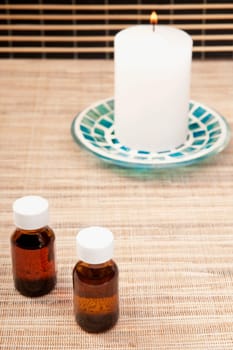 Candle with aromatherapy oil bottles