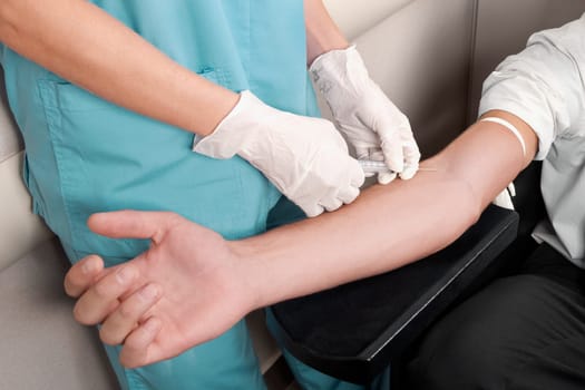 Doctor taking blood sample of a patient