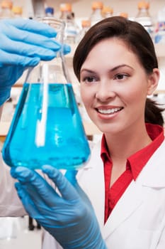 Female doctor holding a conical flask in a laboratory