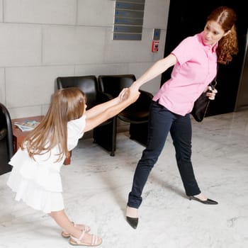 Girl pulling her motherŽs hand in a hospital