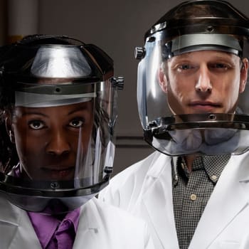 Female and a male doctor wearing protective gears in a laboratory