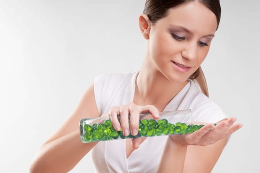 Woman pouring bath beads on her palm
