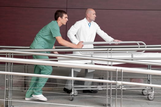 Doctor with a male nurse pushing a stretcher