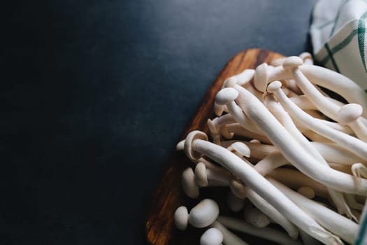 Cooking white mushrooms on the dark gray background. High quality photo
